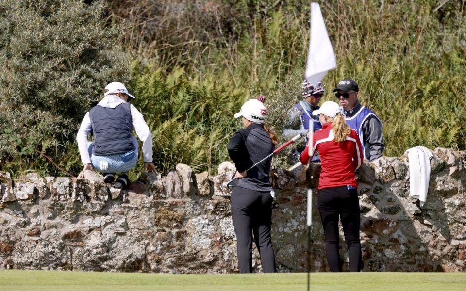 Catriona Matthew of Scotland; Sophia Schubert and Louise Duncan looks for a ball on the bush after Sophia SchubertÂ´s caddie accidentally threw the ball to the bush on the 2nd hole during Day Two of the AIG Women's Open at Muirfield on August 05, 2022 in Gullane, Scotland - GETTY IMAGES 