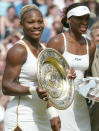 FILE - Serena Williams, left, holds her trophy after defeating her sister Venus, right, to win the women's singles final on the Centre Court at Wimbledon, Saturday, July 6, 2002. Serena won the match 7-6 (7-4), 6-3. Saying “the countdown has begun,” 23-time Grand Slam champion Serena Williams announced Tuesday, Aug. 9, 2022, she is ready to step away from tennis so she can turn her focus to having another child and her business interests, presaging the end of a career that transcended sports. (AP Photo/Ted S. Warren, File)