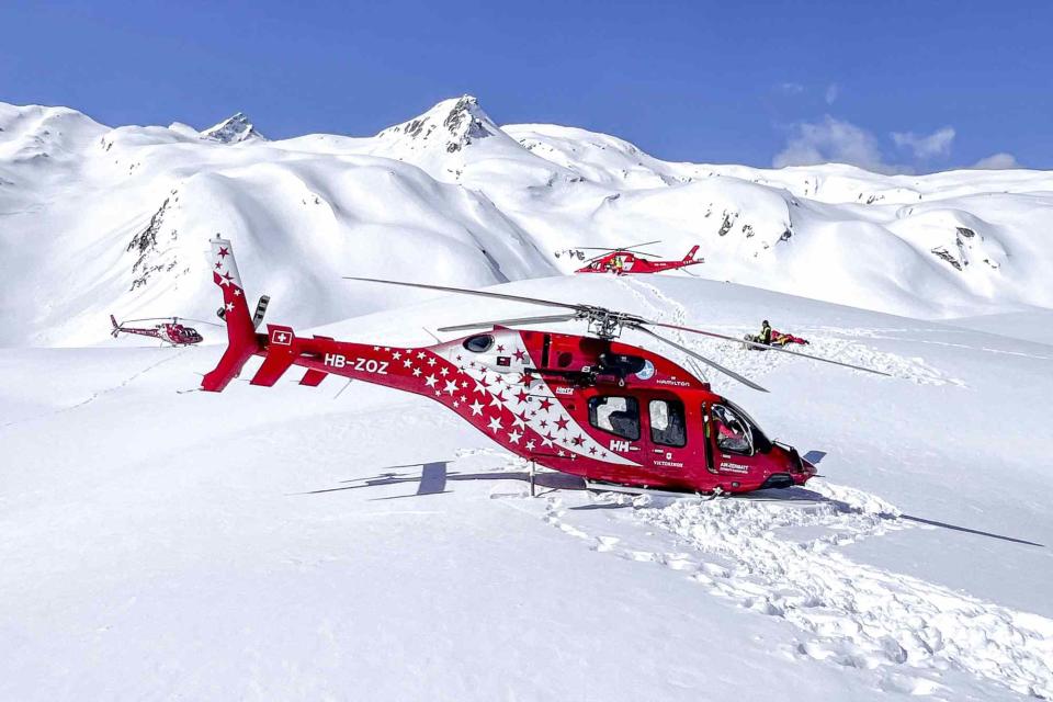 <p>Police of the Canton of Valais/AFP via Getty</p> Helicopters taking part in rescue operations