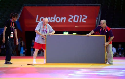 Organisers install tatamis for the judo competition at the Excel centre on July 26 in London, on the eve of the start of the London 2012 Olympic Games. Video replay technology will be used at the Olympic judo competition for the first time in an effort to eradicate judging controversies