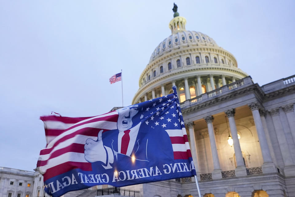 A flag with a image of President Donald Trump left behind by rioters at the U.S. Capitol on Jan. 6, 2021, in Washington. (AP Photo/Manuel Balce Ceneta)