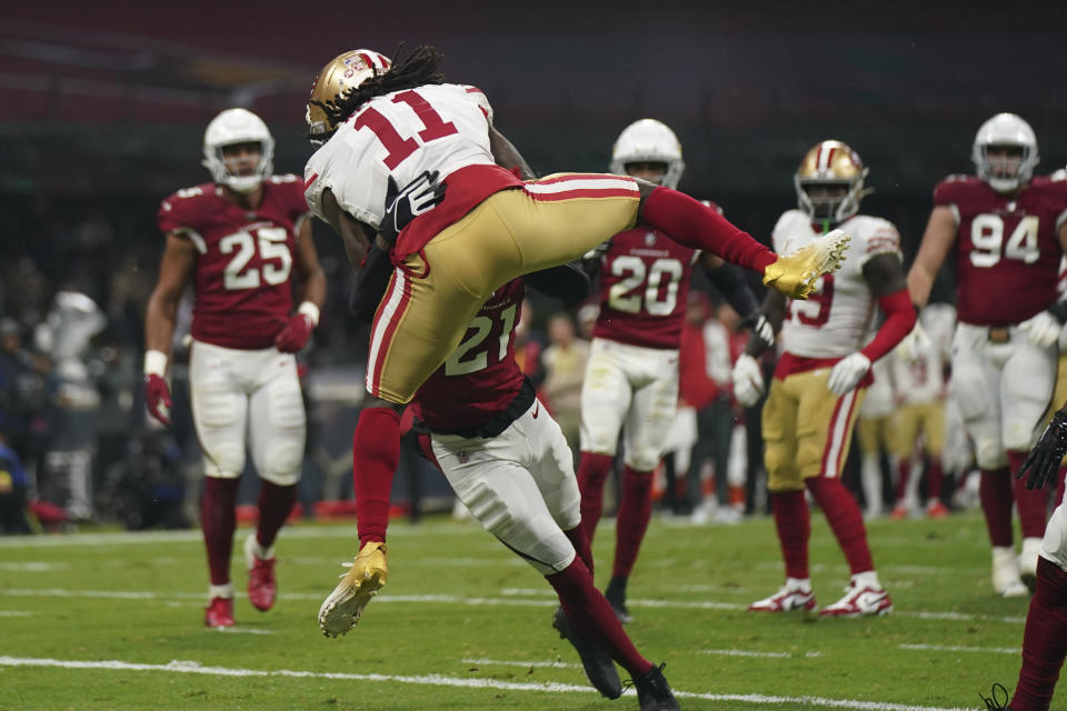 San Francisco 49ers wide receiver Brandon Aiyuk (11) makes a touchdown catch as Arizona Cardinals cornerback Trayvon Mullen, below, defends during the first half of an NFL football game Monday, Nov. 21, 2022, in Mexico City. (AP Photo/Fernando Llano)