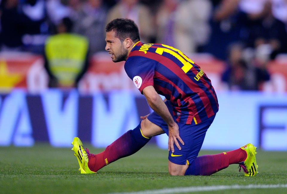 Barcelona's Jordi Alba grimaces while holding his leg during the final of the Copa del Rey between FC Barcelona and Real Madrid at the Mestalla stadium in Valencia, Spain, Wednesday, April 16, 2014. (AP Photo/Manu Fernandez)