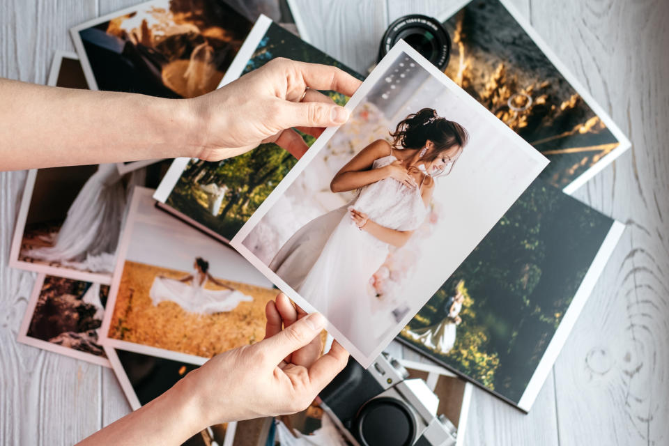 Woman looking through a pile of photographs.