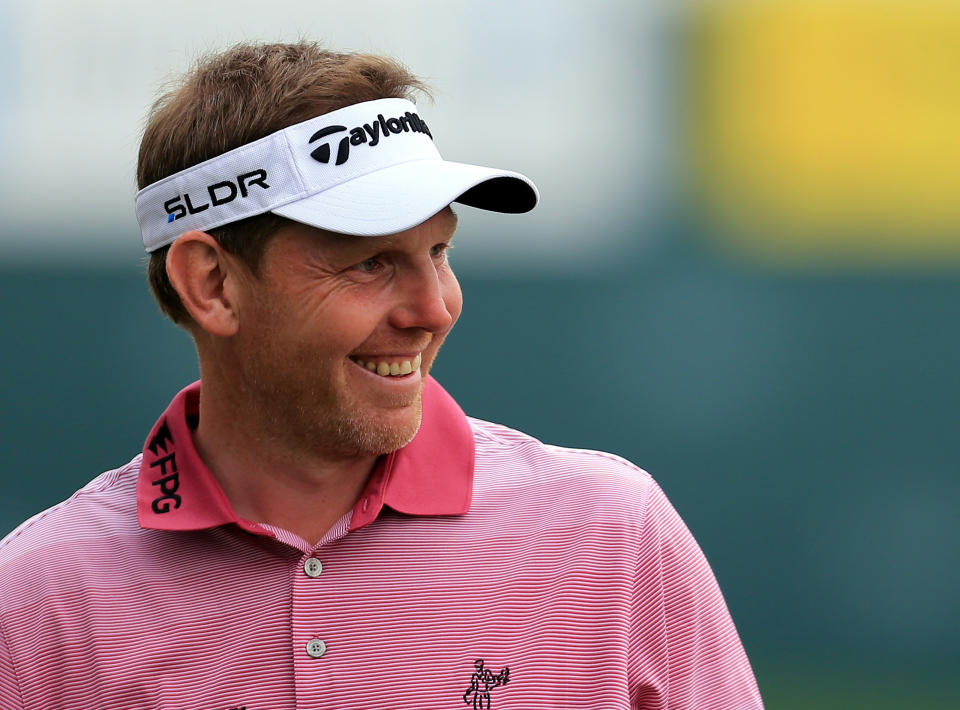 Stephen Gallacher of Scotland acknowledges the crowd on the 18th hole during the third round of the Dubai Desert Classic golf tournament in Dubai, United Arab Emirates, Saturday, Feb. 1, 2014. (AP Photo)