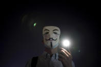 A protester wears a mask during a protest in Hong Kong, Friday, Oct. 18, 2019. Hong Kong pro-democracy protesters are donning cartoon/superhero masks as they formed a human chain across the semiautonomous Chinese city, in defiance of a government ban on face coverings. (AP Photo/Felipe Dana)