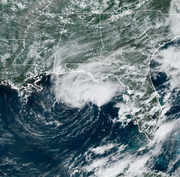 NOAA's GOES EAST satellite captured this image Thursday afternoon of the area of clouds and thunderstorms they're watching in the Gulf of Mexico. The system has a 70% chance of developing into a tropical storm, the National Hurricane Center said, but is expected to be short-lived.