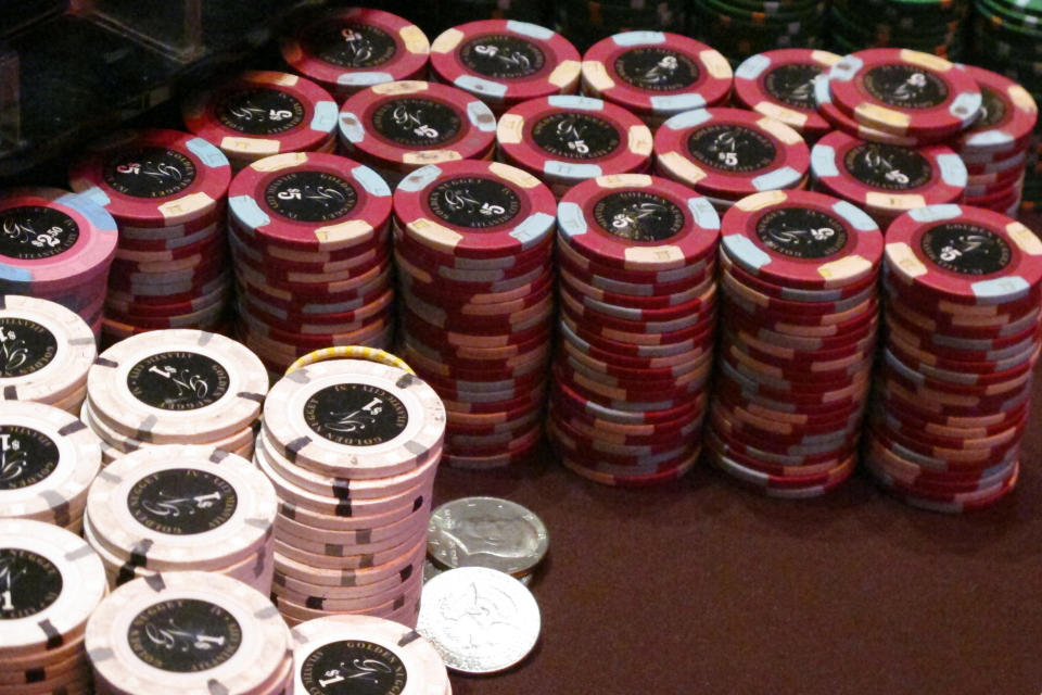 In this Feb. 22, 2019 photo, gambling chips stacked on a table at the Golden Nugget casino in Atlantic City N.J. Commercial casinos in 25 U.S. states won $43.6 billion from gamblers in 2019, an increase of nearly 4% from the previous year, according to a report issued late Wednesday, June 3, 2020, by The American Gaming Association, the casino industry’s national trade group. (AP Photo/Wayne Parry)