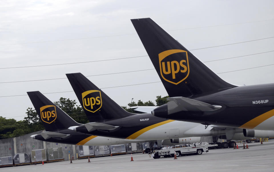 FILE - In this July 27, 2020 file photo, the tails of three UPS aircraft are shown parked at Miami International Airport in Miami. Carriers like the U.S. Postal Service, FedEx and United Parcel Service have capacity to meet projected demand this holiday season, which is cheery news for shippers and shoppers alike. (AP Photo/Wilfredo Lee, File)