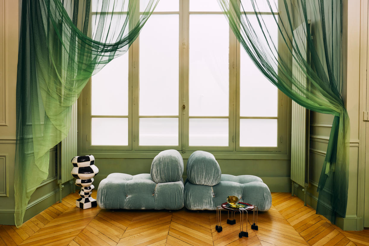  A living room with green chairs and curtains. 