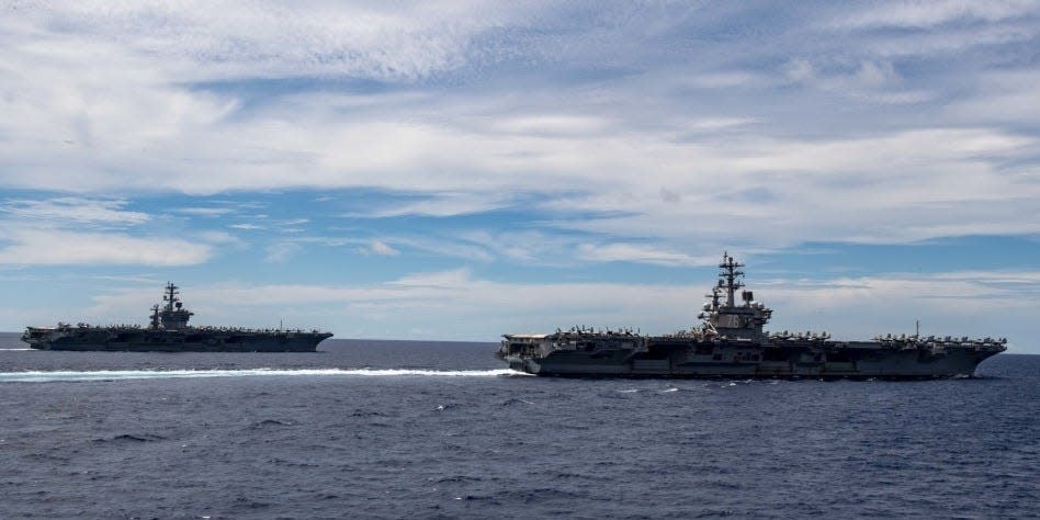 The Nimitz-class aircraft carriers USS Nimitz (CVN 68) and Ronald Reagan (CVN 76) transit the South China Sea. The USS Nimitz (CVN 68) and USS Ronald Reagan (CVN 76) Carrier Strike Groups are conducting dual carrier operations in the Indo-Pacific