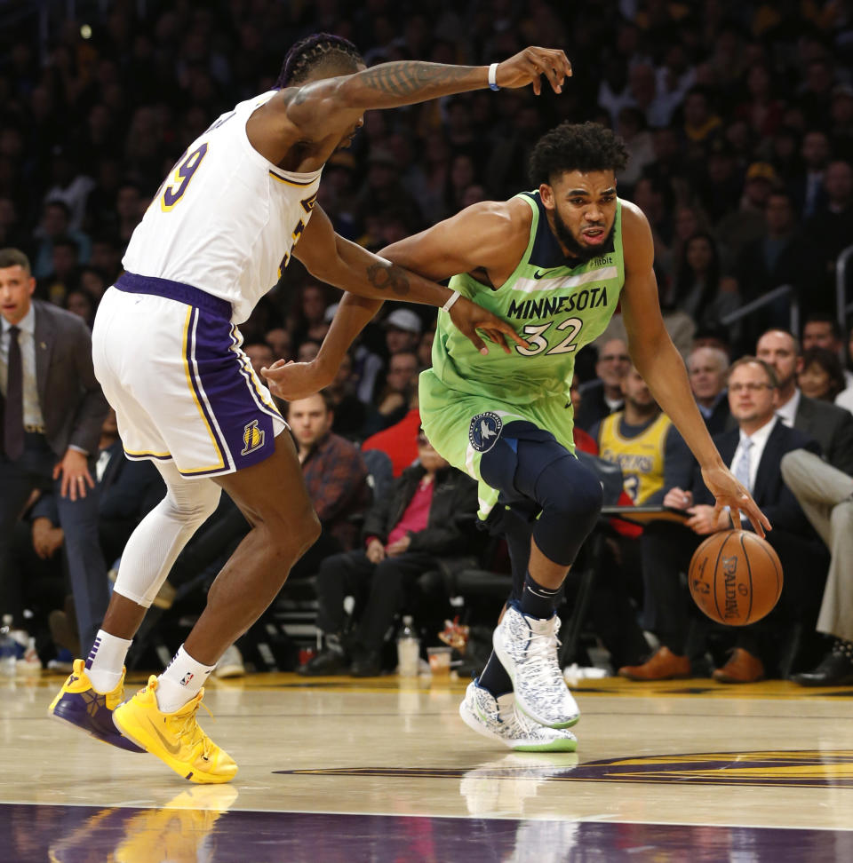 LOS ANGELES, CALIFORNIA - DECEMBER 08:  Karl-Anthony Towns #32 of the Minnesota Timberwolves drives around Dwight Howard #39 of the Los Angeles Lakers during the first half at Staples Center on December 08, 2019 in Los Angeles, California. NOTE TO USER: User expressly acknowledges and agrees that, by downloading and or using this photograph, User is consenting to the terms and conditions of the Getty Images License Agreement. (Photo by Katharine Lotze/Getty Images)