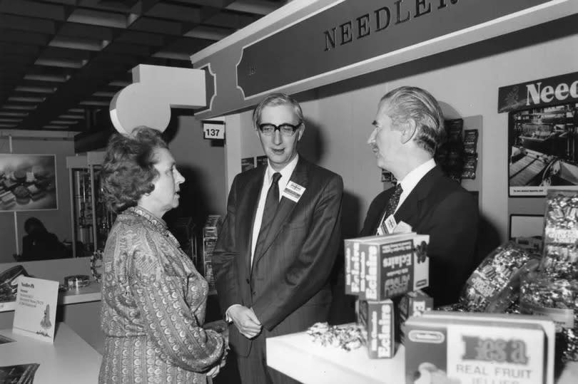 Mrs Peggy Fenner MP visited the Needler stand at the International Sweet Manufacturers trade fair stand in Cologne. She is pictured with company chairman Raymond Needler, middle, and marketing director Norman Glassford, dated 22-1-1984