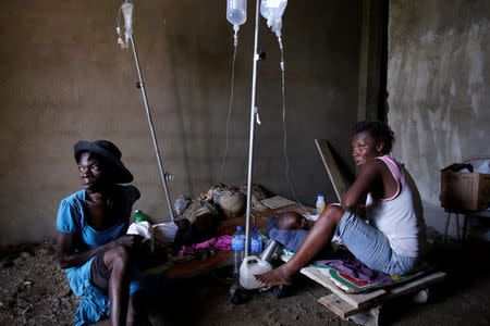 Two women take care of two children receiving treatment for cholera after Hurricane Matthew in the Hospital of Port-a-Piment, Haiti, October 9, 2016. REUTERS/Andres Martinez Casares