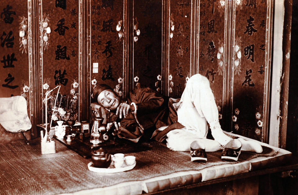 In this photo taken in about 1920 and released by American author Steven Martin, a Chinese man smokes in a very upscale opium den in China. One Halloween night, in a blacked-out bedroom in Bangkok's Chinatown, Steven Martin went into physical and mental free fall. High fever oscillated with shivering cold, gut-wrenching stomach pains brought on waves of diarrhea. Howling in agony, he leapt around the room in a kind of devil dance, his body smeared with oily sweat, vomit, mucus and feces. "Opium Fiend, A 21st Century Slave to a 19th Century Addiction'' opens with this harrowing description of the author trying to cut himself off from a drug that had taken over his life as a freelance journalist in Southeast Asia. Although Martin doesn't advocate the use of opium, his memoir is no simple cautionary tale, nor was he your ordinary backpacker junkie, such as still roam this region of cheap and plentiful drugs. (AP Photo/Courtesy of Steven Martin) EDITORIAL USE ONLY, NO SALES