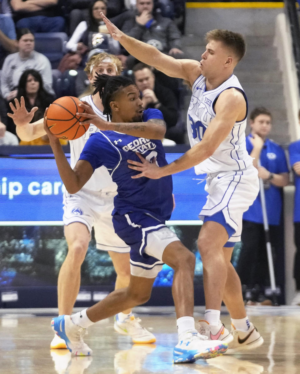 BYU guard Dallin Hall (30) defends against Georgia State guard Julian Mackey during the first half of an NCAA college basketball game Saturday, Dec. 16, 2023, in Provo, Utah. (AP Photo/Rick Bowmer)