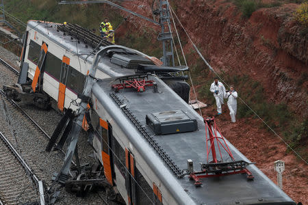 Rescue workers survey the scene after a commuter train derailed between Terrassa and Manresa, outside Barcelona, Spain, November 20, 2018. REUTERS/Albert Gea
