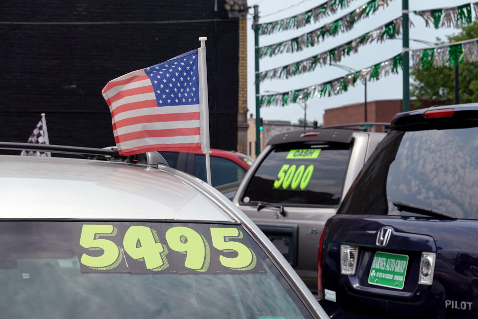 Used cars are offered for sale at a dealership.