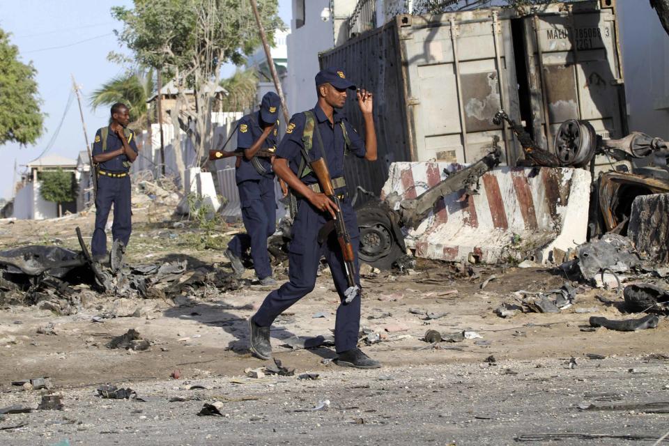 Security guards assess the aftermath at the scene of an explosion outside Jazira hotel in Mogadishu