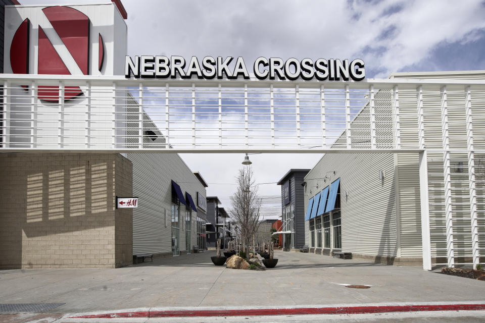 The Nebraska Crossing Outlet shopping mall is seen in Gretna, Neb., Tuesday, April 14, 2020. The outlet mall near Omaha plans to reopen later this month even as the number of coronavirus cases and deaths continues to grow in the state. The owner of the Nebraska Crossing Outlets says their experience will be a case study of best practices for other malls although it is not immediately clear how many stores will reopen when the mall does. (AP Photo/Nati Harnik)
