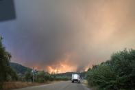 Flames approaching at Gouves village on the island of Evia, about 185 kilometers (115 miles) north of Athens, Greece, Sunday, Aug. 8, 2021. Hundreds of firefighters in Greece are still battling massive wildfires that have destroyed tracts of forest and prompted emergency evacuations from a popular vacation island. (AP Photo/Petros Karadjias)