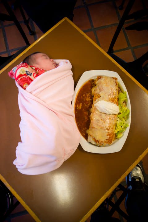 A baby is pictured next to a Gorditos burrito