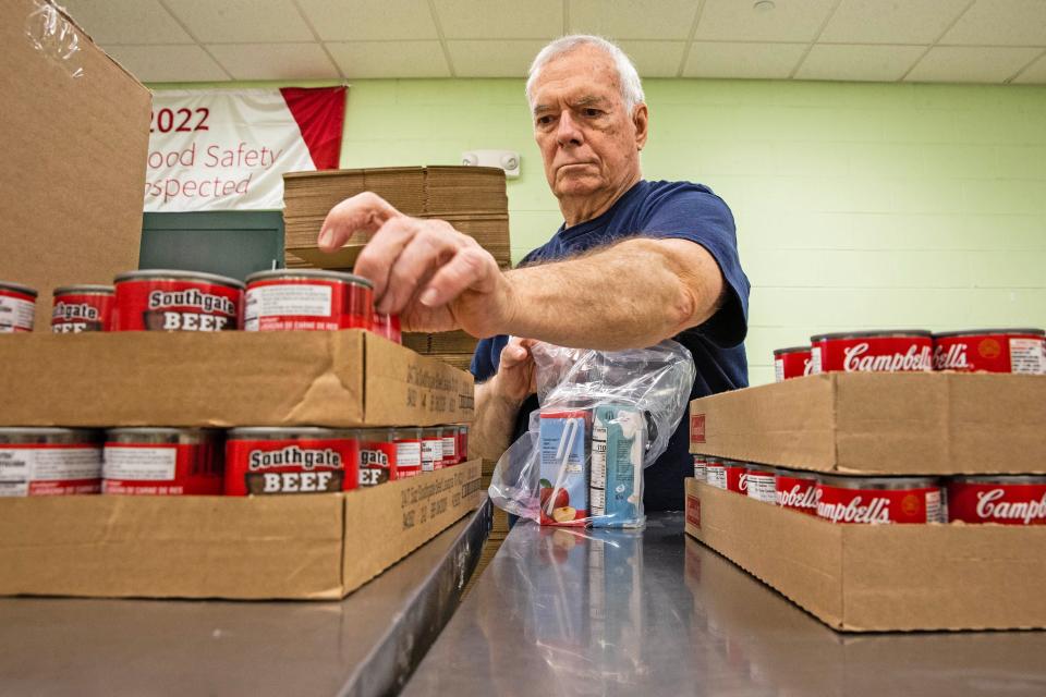 David Snyder, a volunteer for three and a half years at the Food Bank of Delaware, organizes canned goods in the volunteer room of the Food Bank in Milford, Friday, Nov. 10, 2023.