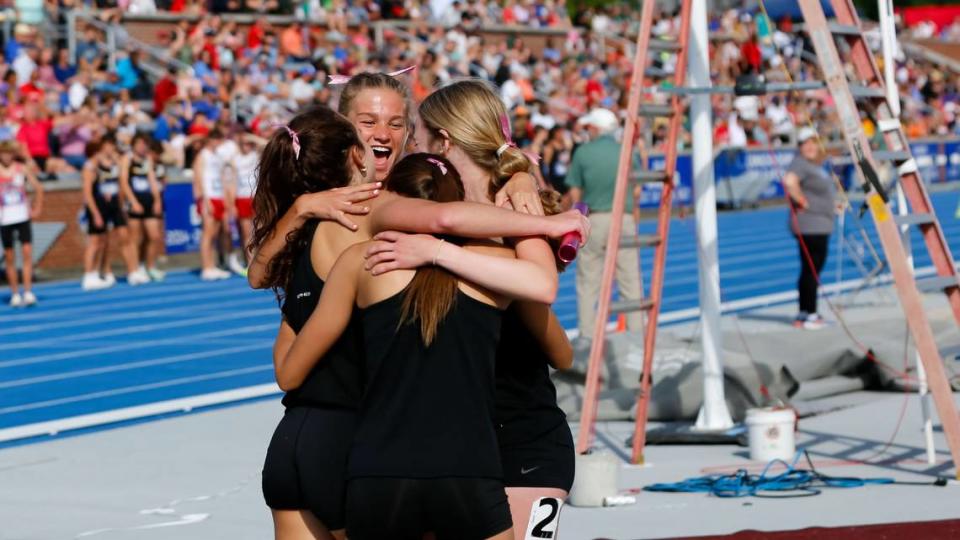 Assumption’s Leah Pennick, at back, celebrates with teammates, from left, Reagan Gilmore, Julia Schmitt and Mabel George, after they won the 4-by-400 meter relay race with a time nearly 10 seconds faster that their own state record set last year.