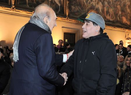 Argentinian soccer legend Diego Armando Maradona shakes hands with former Napoli's soccer team president Corrado Ferlaino during the Italian soccer Hall of Fame 2017 event in Florence, Italy, January 17, 2017. REUTERS/Paolo Lo Debole