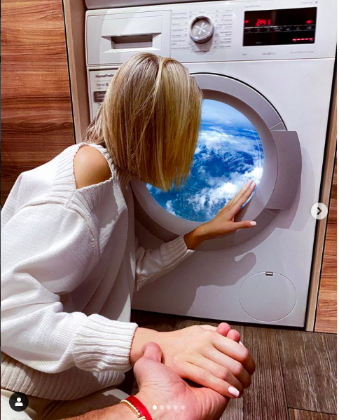 Nataly looking through the washing machine at home (Screengrab from Murad Osmann’s Instagram)