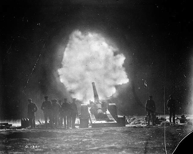 <p>A naval gun belonging to Allied forces illuminates its immediate surroundings as it fires at German positions at Vimy Ridge in May 1917. Photo from Library and Archives Canada. </p>