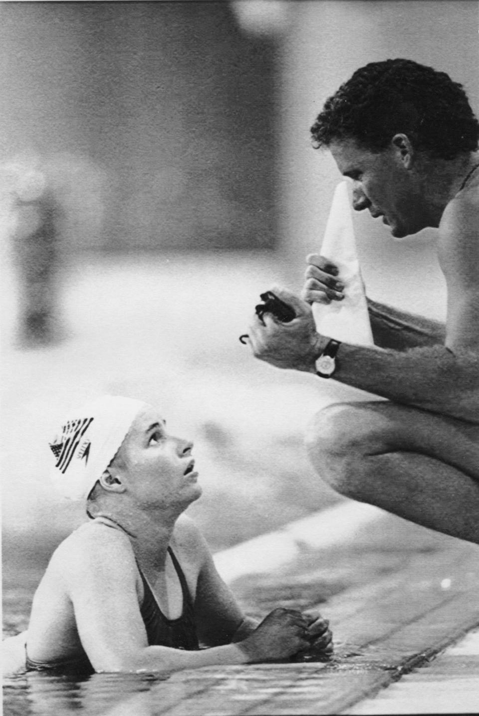 In this Aug. 18, 1991 file photo, Allison Bock plots pre-race strategy with David Marsh, a Pan American men's assistant, during the 1991 Pan American Games in Havana, Cuba.