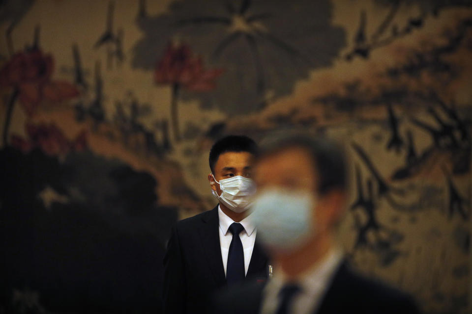 A security officer wearing a face mask to protect against the new coronavirus stands guard before the opening session of the Chinese People's Political Consultative Conference (CPPCC) at the Great Hall of the People in Beijing, Thursday, May 21, 2020. (AP Photo/Andy Wong, Pool)