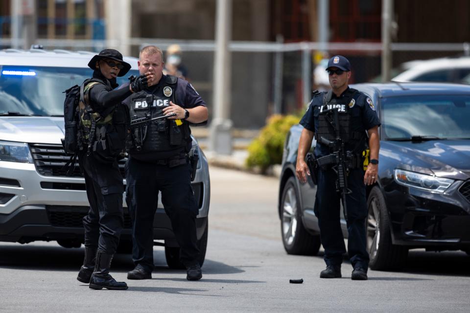 Grandmaster Jay, leader of NFAC, speaks with police before a march of his group and supporters on July 25, 2020, in Louisville.