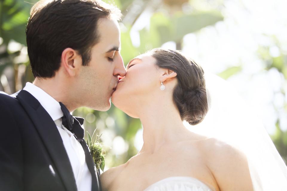 The bride wore Oscar de la Renta, inspired by her grandmother, for her greenery-filled ceremony at the Beverly Hills Hotel.