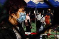 People queue up at a makeshift community testing centre for the coronavirus disease (COVID-19), in Hong Kong