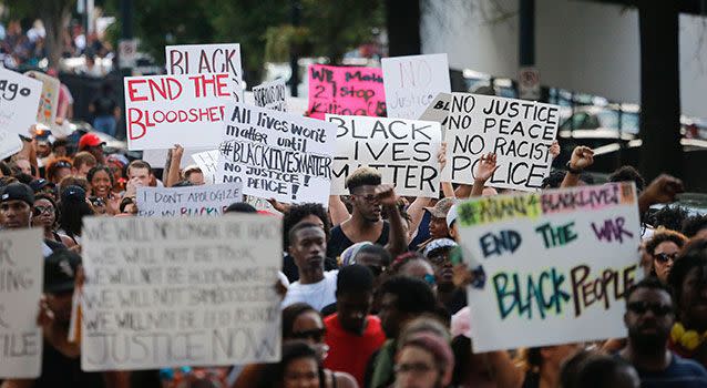 Demonstrators march through downtown Atlanta to protest the shootings of two black men by police officers. Photo: AP Photo/John Bazemore