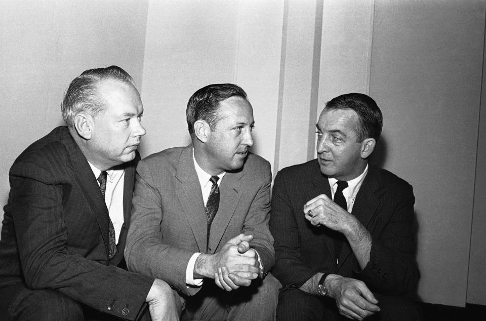 FILE - In this February 1966 file photo, NFL commissioner Pete Rozelle, center, discusses a new television contract for championship games with Bill MacPhail, left, vice president of CBS-TV, and John Reynolds, president of CBS-TV network, in Palm Beach, Fla. Pete Rozelle would not be surprised to see the NFL’s impact of television as it celebrates its 100th season this year. It was Rozelle, the commissioner from 1960 to 1989, who was able to convince owners that it was in their best interest to sign a leaguewide rights deal instead of teams negotiating on their own. (AP Photo/File)