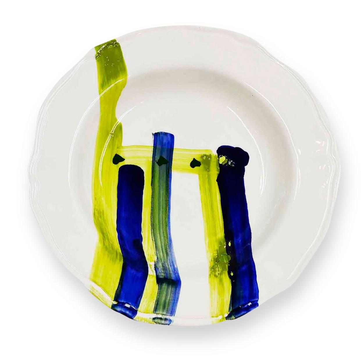 white soup plate with vertical watercolor strokes in lime yellow and dark blue