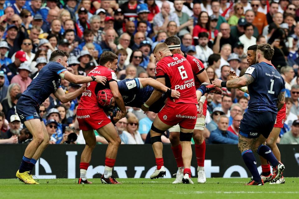 Josh van der Flier of Leinster is picked up by Juan Cruz Mallia and Jack Willis of Stade Toulousain (Getty Images)