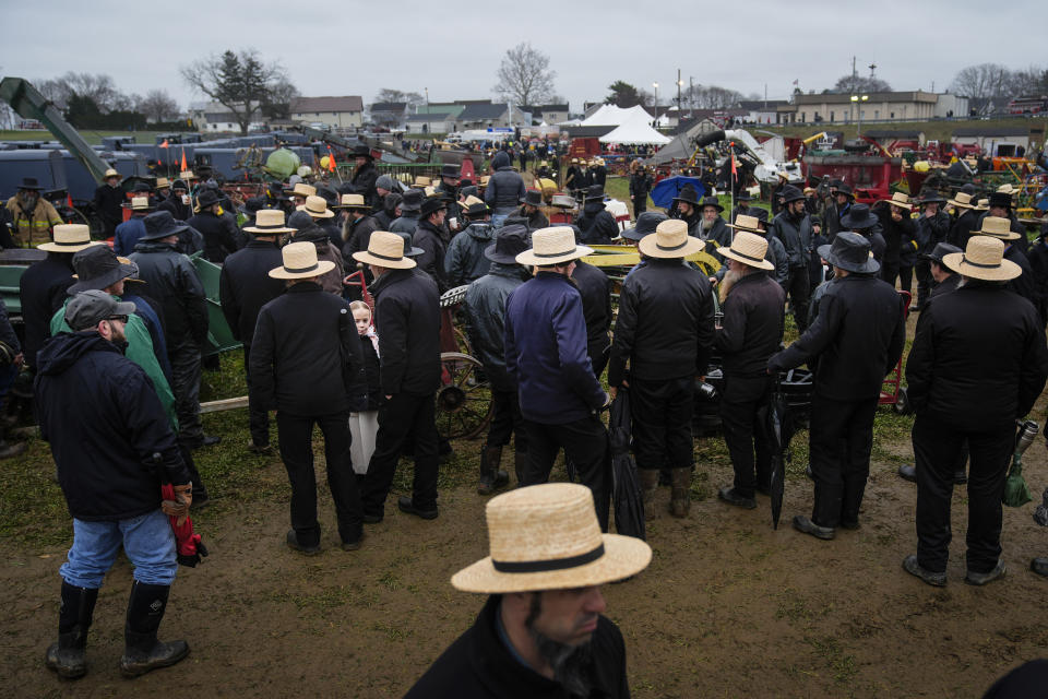 People gather for an auction of farm equipment during 56th annual mud sale to benefit the local fire department in Gordonville, Pa., Saturday, March 9, 2024. Mud sales are a relatively new tradition in the heart of Pennsylvania's Amish country, going back about 60 years and held in early spring as the ground begins to thaw but it's too early for much farm work. (AP Photo/Matt Rourke)