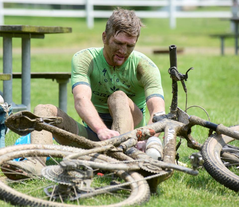 Jeff Pendlebury of Shreve in Wayne County cleans off after finishing third overall Saturday in the 100 kilometer event during the Mohican Mountain Bike race.