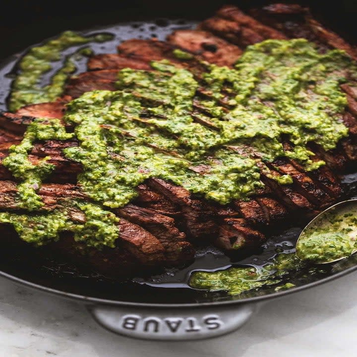 Flank steak topped with green herb sauce.