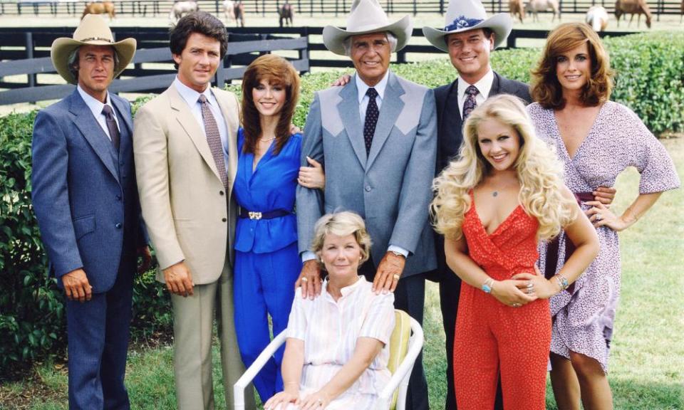 The cast of Dallas, 1979. From left: Steve Kanaly (Ray Krebbs), Patrick Duffy (Bobby Ewing), Victoria Principal (Pamela Barnes Ewing), Barbara Bel Geddes, sitting (‘Miss Ellie’ Ewing), Jim Davis (Jock Ewing), Larry Hagman (JR), Charlene Tilton (Lucy Ewing) and Linda Gray (Sue Ellen Ewing).