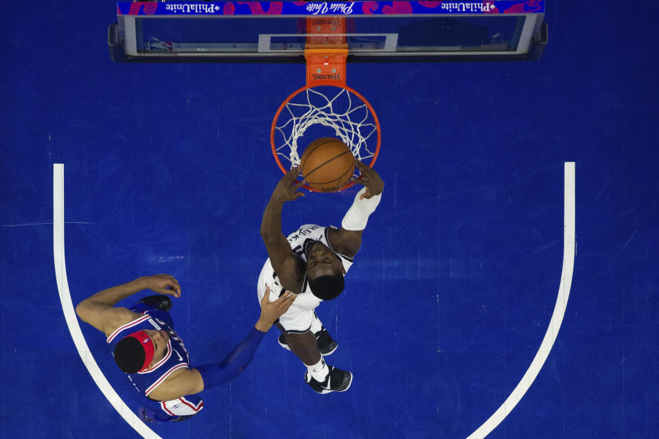 Brooklyn Nets' Caris LeVert, right, dunks the ball as Philadelphia 76ers' Tobias Harris, left, defends during the first half in Game 1 of a first-round NBA basketball playoff series, Saturday, April 13, 2019, in Philadelphia. (AP Photo/Chris Szagola)
