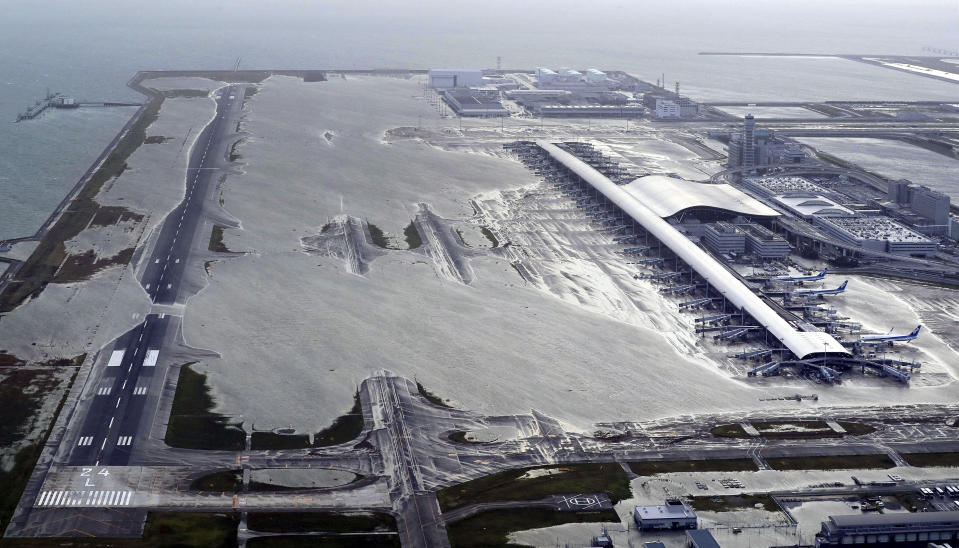 Kansai International Airport is partly inundated following a powerful typhoon in Izumisano, Osaka prefecture, western Japan, Tuesday, Sept. 4, 2018. A powerful typhoon blew through western Japan on Tuesday, causing heavy rain to flood the region's main offshore international airport and high winds to blow a tanker into a connecting bridge, disrupting land and air travel. (Kentaro Ikushima/Mainichi Newspaper via AP)