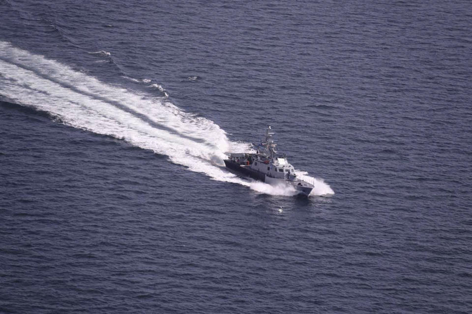 In this photo released Tuesday, Feb. 16, 2021, by the Iranian army, an Iranian Revolutionary Guard warship moves in a ceremony to welcome Russian warship to Iranian waters for a joint naval exercise with the Iranian navy and Iran's Revolutionary Guard navy. Iranian and Russian militaries have kicked off a joint naval drill in the Indian Ocean aimed at boosting security of maritime trade in the region, Iran's state TV reported on Tuesday. (Iranian Army via AP)