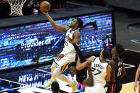 Utah Jazz guard Donovan Mitchell (45) goes to the basket as center Rudy Gobert (27) defends Miami Heat center Bam Adebayo, center, during the first half of an NBA basketball game, Friday, Feb. 26, 2021, in Miami. (AP Photo/Lynne Sladky)