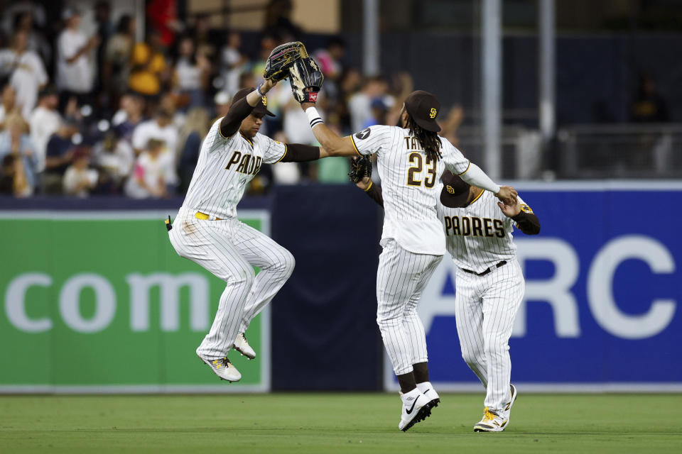 San Diego Padres' Juan Soto, left, celebrates with Fernando Tatis Jr. (23) and Trent Grisham after the team's win over the Pittsburgh Pirates in a baseball game Tuesday, July 25, 2023, in San Diego. (AP Photo/Derrick Tuskan)