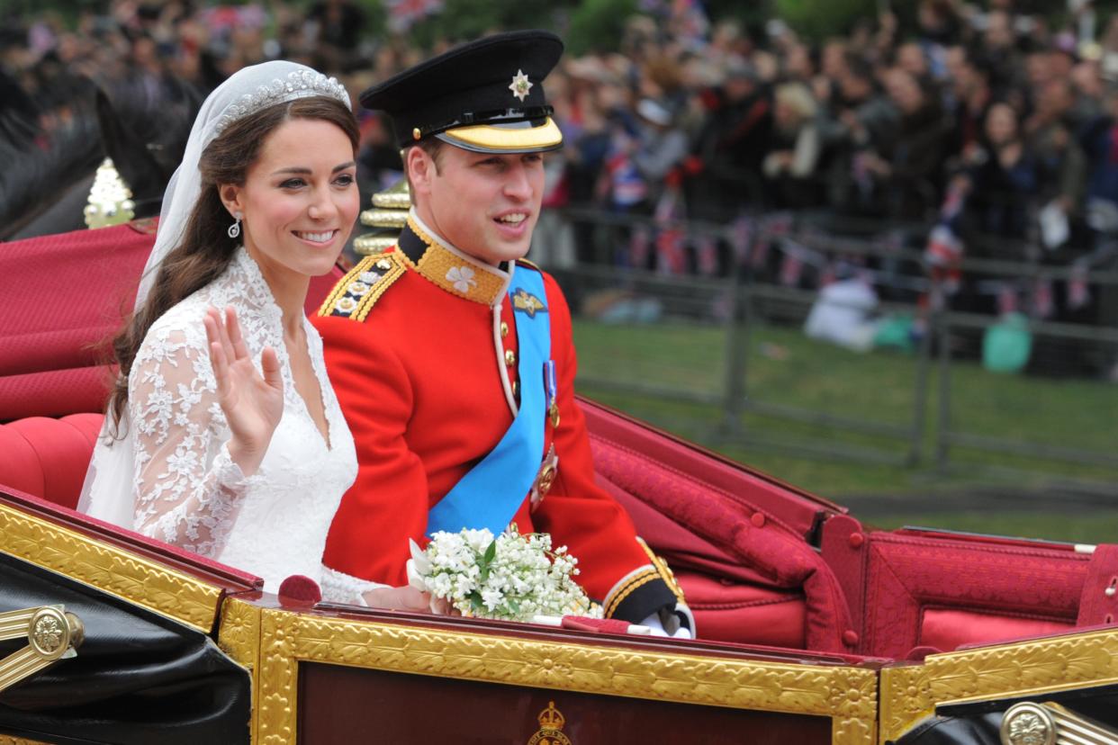 Kate and William travel in the 1902 State Landau along the processional route to Buckingham Palace after their wedding (Dimitar Dilkoff/PA) (PA Archive)